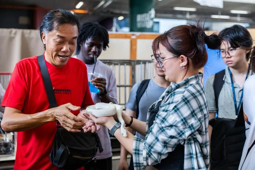 Visitors meeting a small animal at an event