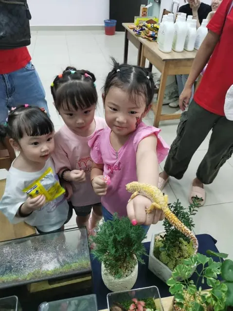 Two children holding small plants
