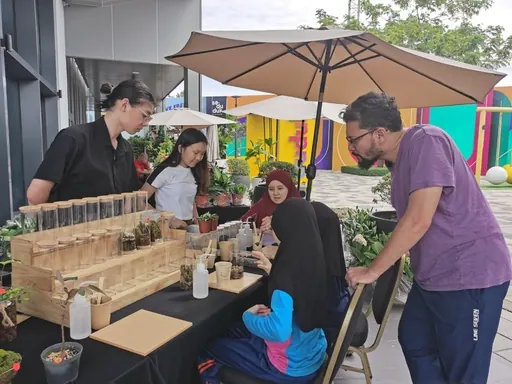 An outdoor workshop under an umbrella