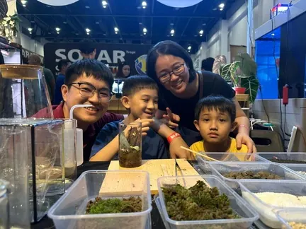 A family at a workshop table in a mall
