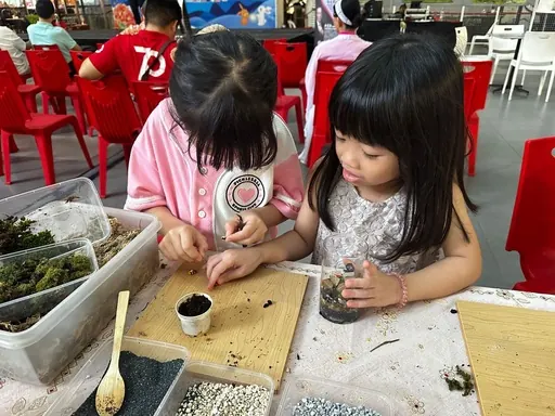 Two girls at a workshop table