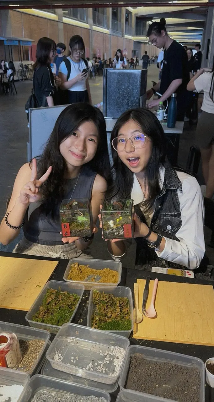 Two guests with the terrariums they made