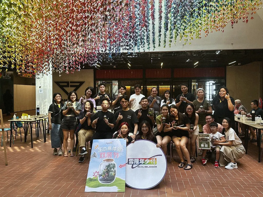A large group in front of an event backdrop